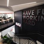 ALKU's Andover office space, with connecting staircase and Have Fun Working Hard motto on display.