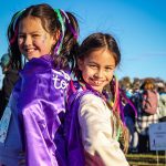 Two girls smiling at the camera.